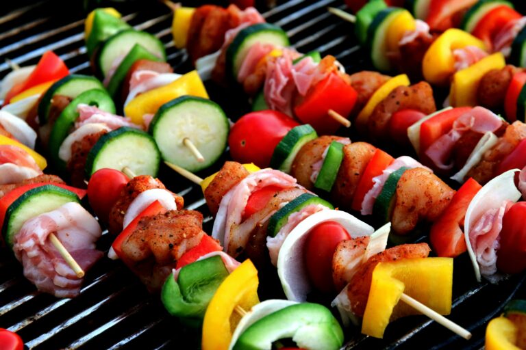 skewers of meat and vegetables on a grill