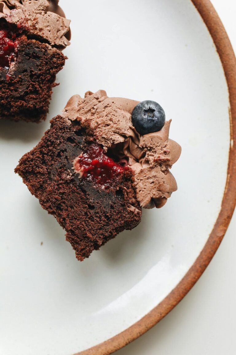 a brownie with chocolate frosting and blueberries on a plate